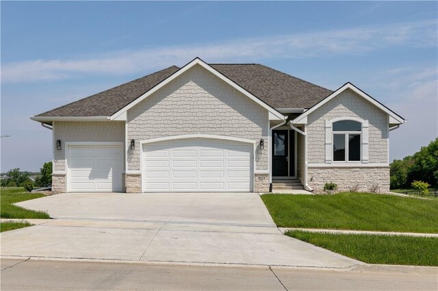 view of front of property with a front yard and a garage