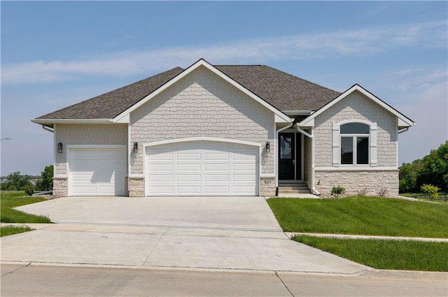 view of front of home featuring a garage and a front lawn