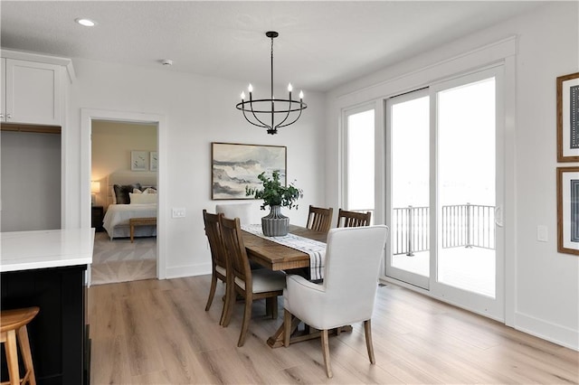 dining room featuring light hardwood / wood-style flooring and a notable chandelier