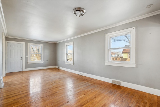 unfurnished room featuring light hardwood / wood-style flooring and crown molding