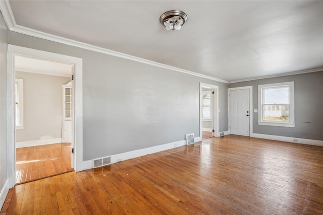 interior space featuring wood-type flooring and ornamental molding