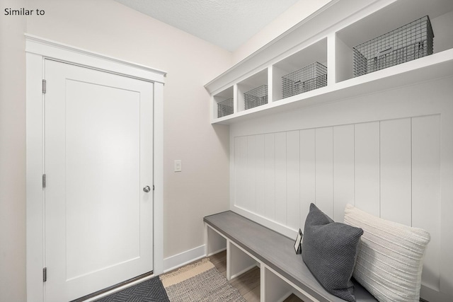 mudroom with a textured ceiling