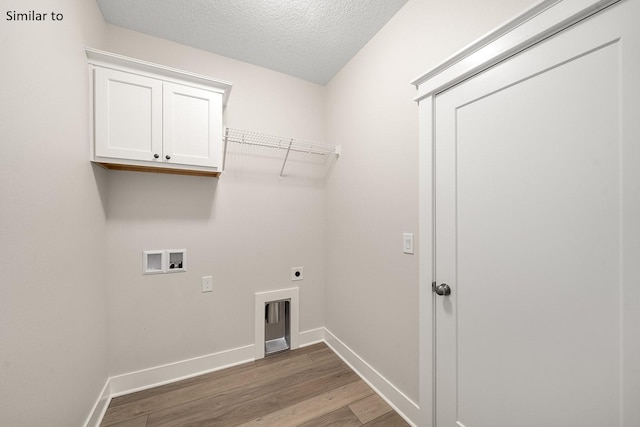 laundry room with hookup for an electric dryer, hookup for a washing machine, cabinets, a textured ceiling, and wood-type flooring