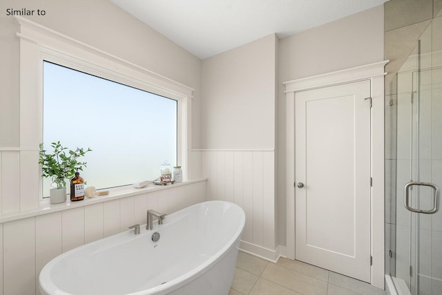 bathroom featuring tile patterned flooring and shower with separate bathtub