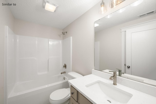 full bathroom featuring vanity, a textured ceiling, shower / bath combination, and toilet