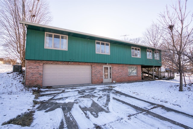 view of front facade with central AC unit and a garage