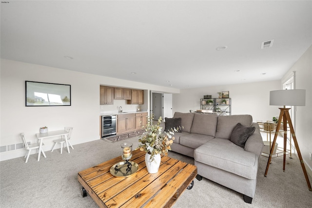 carpeted living room featuring wine cooler