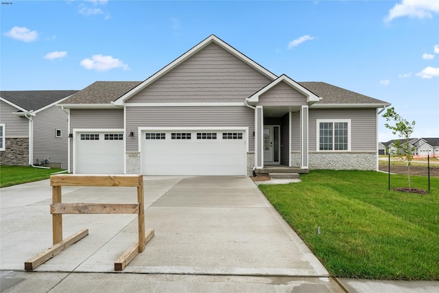 craftsman-style home with a front lawn and a garage