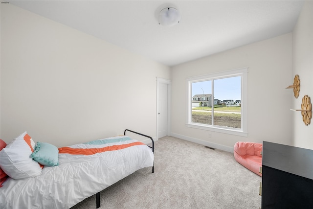 bedroom featuring light colored carpet