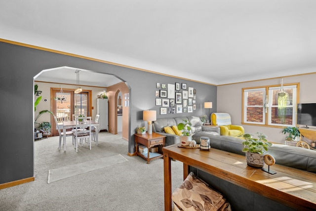 carpeted living room with ornamental molding