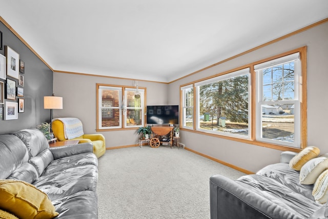 carpeted living room with a healthy amount of sunlight and ornamental molding