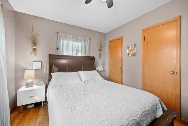 bedroom with hardwood / wood-style floors and ceiling fan