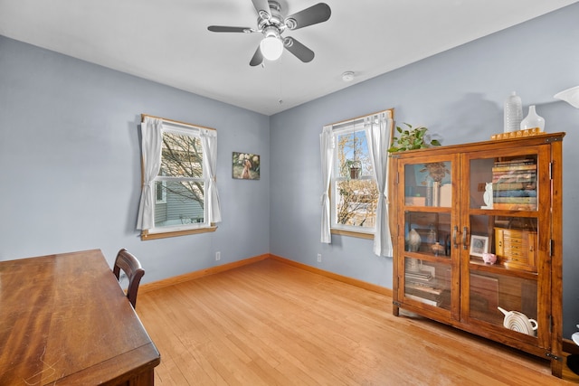 office area with ceiling fan and light hardwood / wood-style flooring