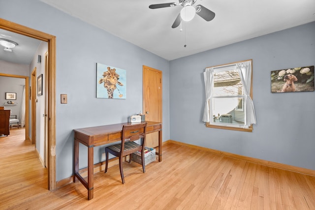 office space with light wood-type flooring and ceiling fan