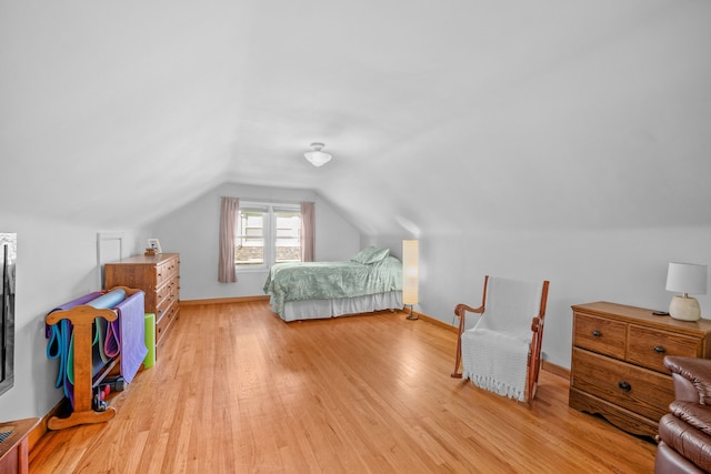 bedroom featuring vaulted ceiling and light hardwood / wood-style flooring