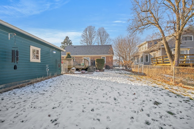 snow covered property featuring a wooden deck