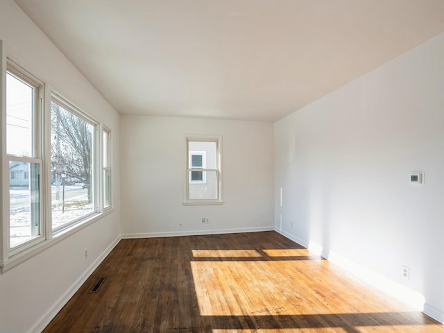 unfurnished room with hardwood / wood-style floors