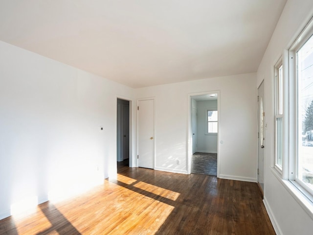 empty room with dark wood-type flooring