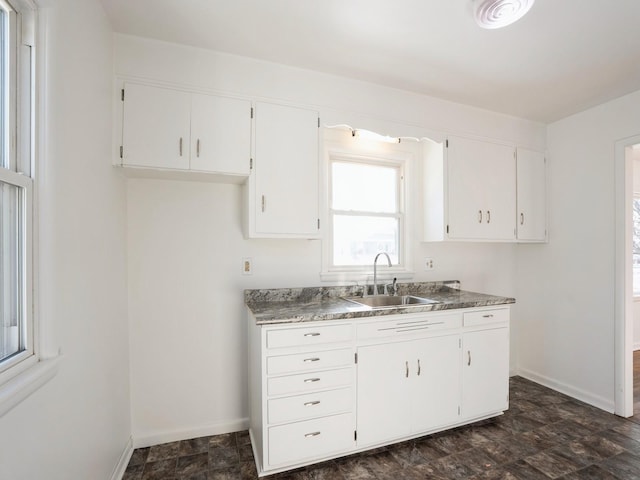 kitchen with white cabinetry and sink