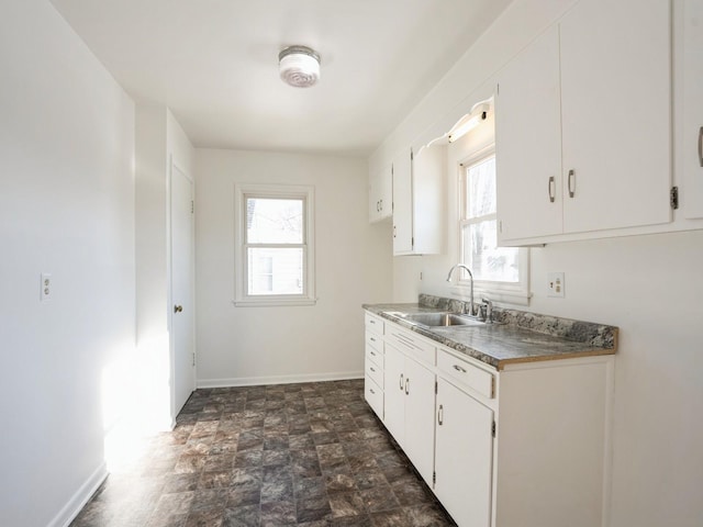 kitchen with white cabinetry and sink