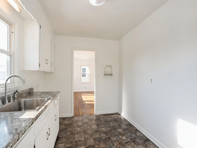 kitchen with white cabinetry and sink