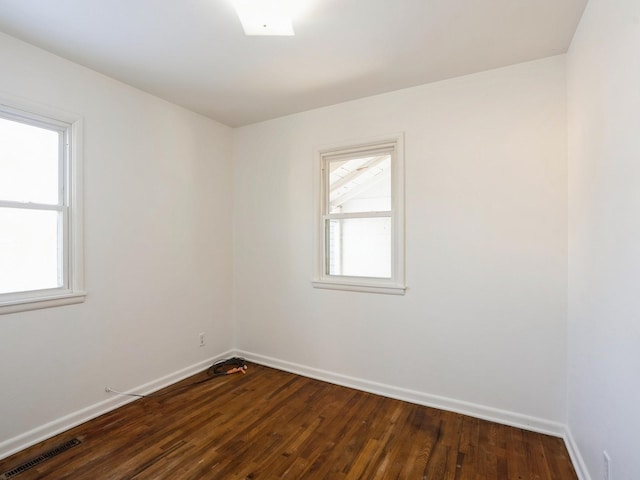 empty room with dark wood-type flooring