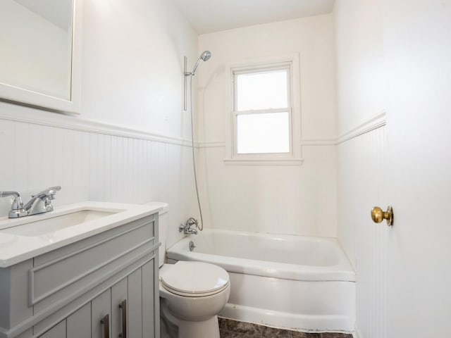 full bathroom featuring washtub / shower combination, vanity, and toilet