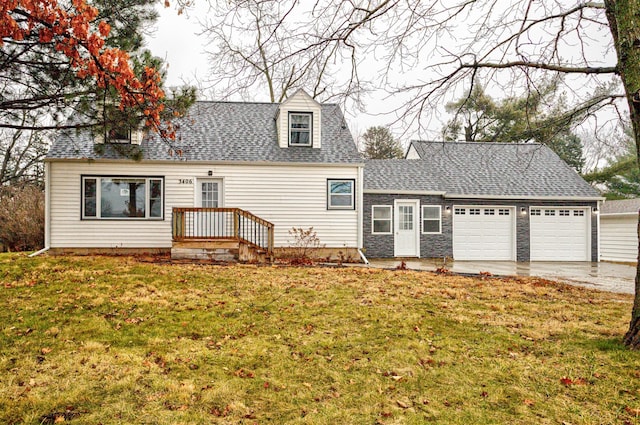 new england style home with a front yard and a garage