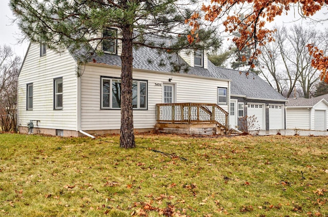 rear view of property featuring a lawn and a wooden deck