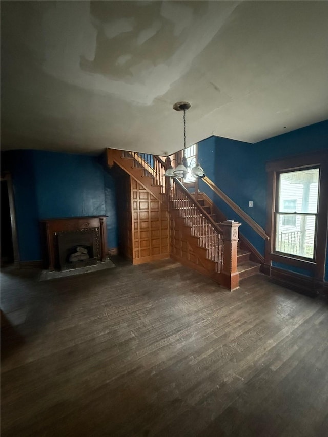 unfurnished living room with dark hardwood / wood-style floors and plenty of natural light