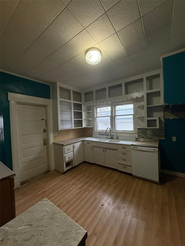 kitchen featuring white cabinets, built in features, sink, and white dishwasher