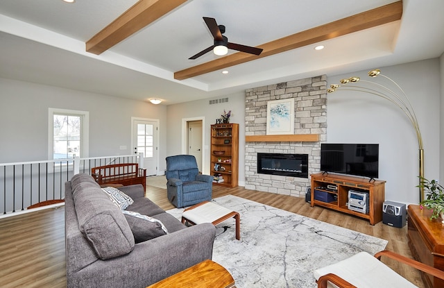 living room with ceiling fan, a fireplace, and hardwood / wood-style floors