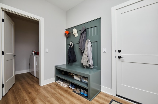 mudroom with washer and dryer and wood-type flooring