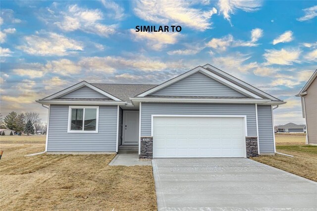 view of front of property with a garage and a front lawn