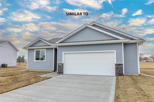 view of front of house with cooling unit, a garage, and a front yard