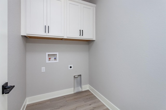 laundry area featuring cabinets, hookup for a washing machine, light wood-type flooring, and electric dryer hookup