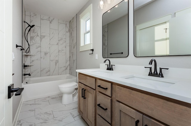 full bathroom featuring vanity, tiled shower / bath combo, and toilet