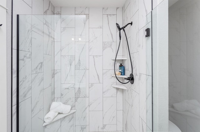 bathroom with tiled shower