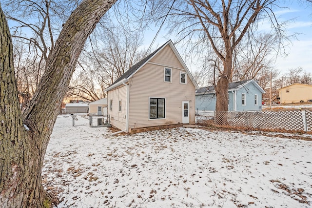 view of snow covered rear of property