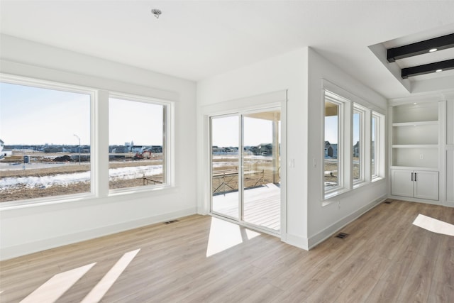 unfurnished sunroom with visible vents