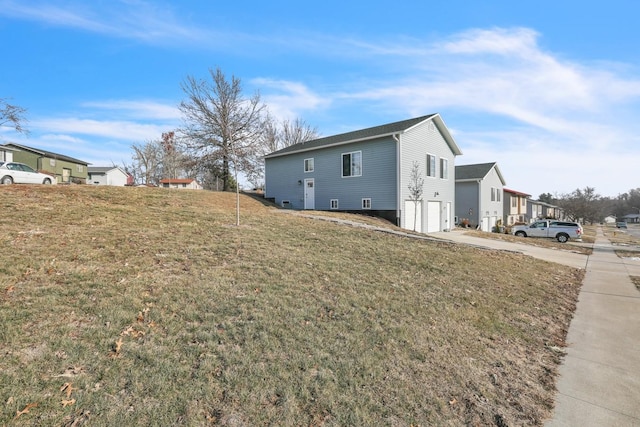 view of home's exterior with a lawn and a garage