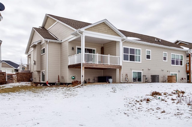 snow covered house with central AC unit