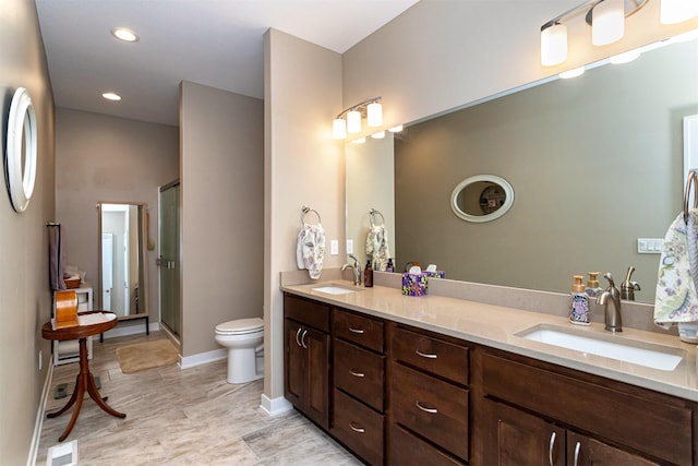 490 Bella Vista Ct, Huxley, IA 50124 - bathroom featuring double vanity, toilet, a stall shower, baseboards, and recessed lighting