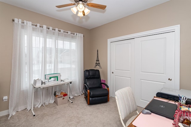 office space with ceiling fan and light colored carpet