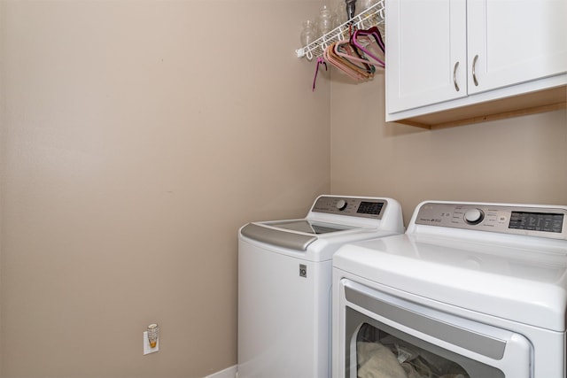 laundry area featuring cabinets and separate washer and dryer