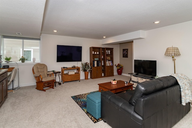 carpeted living room with a textured ceiling