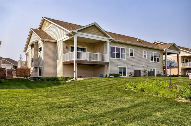 490 Bella Vista Ct, Huxley, IA 50124 - back of property featuring a lawn, a shingled roof, and central AC unit