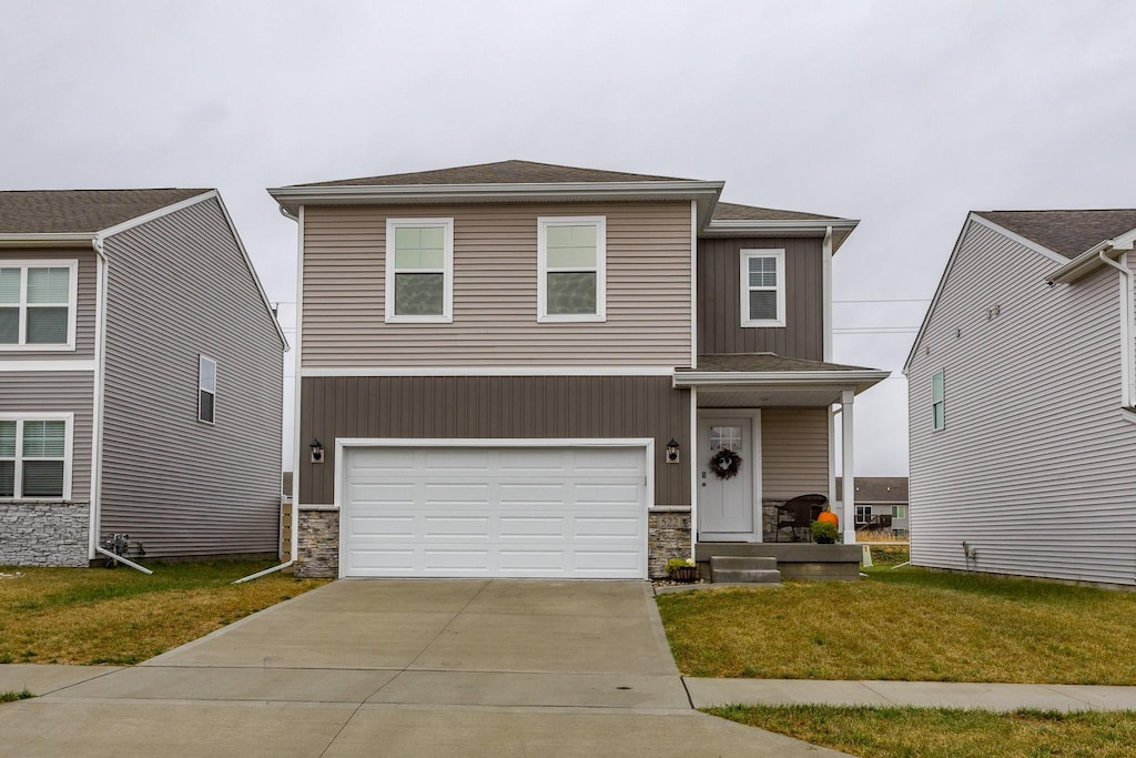 view of front of property with a garage and a front lawn