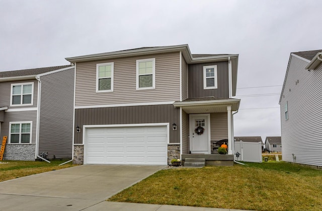 view of front of property with a front yard and a garage