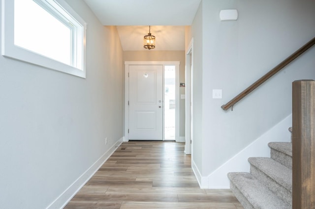 foyer with a chandelier and light hardwood / wood-style flooring